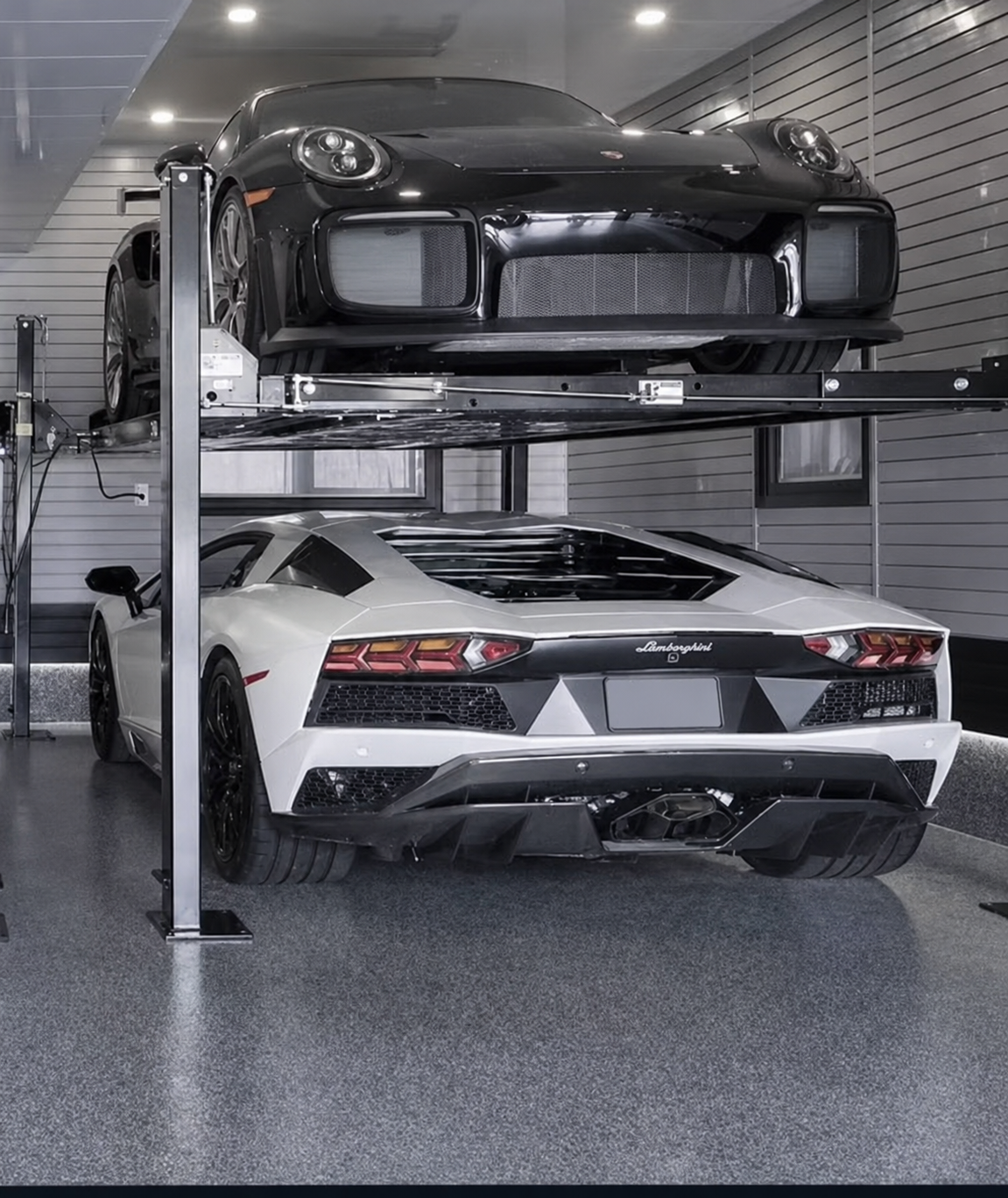 BendPak four-post parking lift with two vehicles stacked