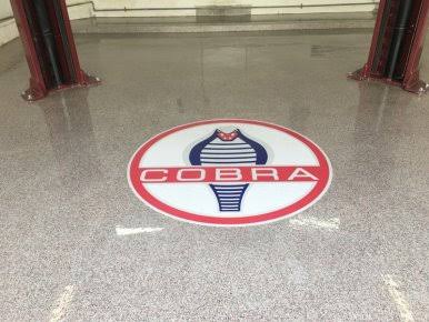 Cobra emblem embedded in garage floor coating