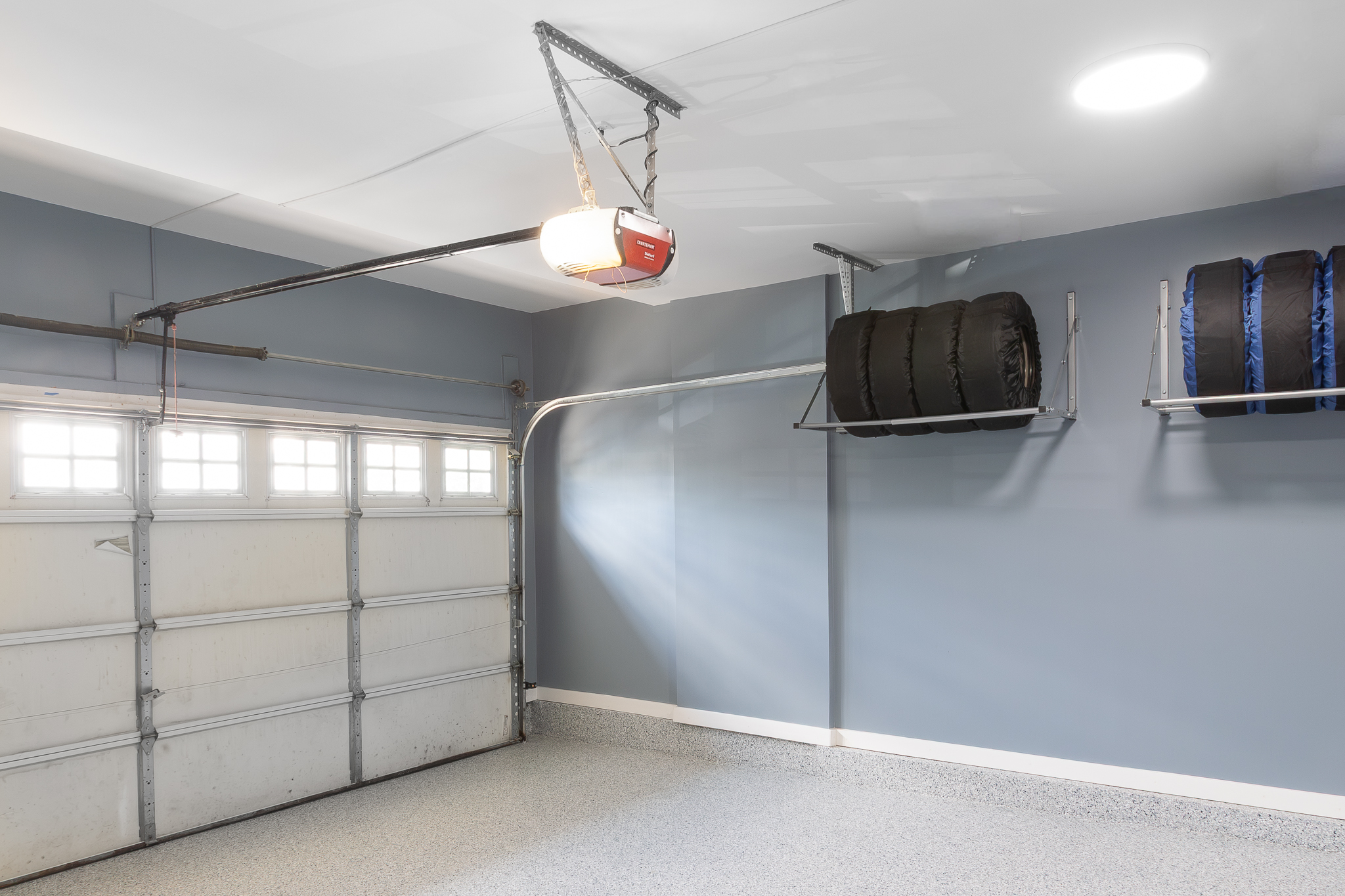 Overhead tire racks over finished flake floor, Pinnacle Garage Works completed job