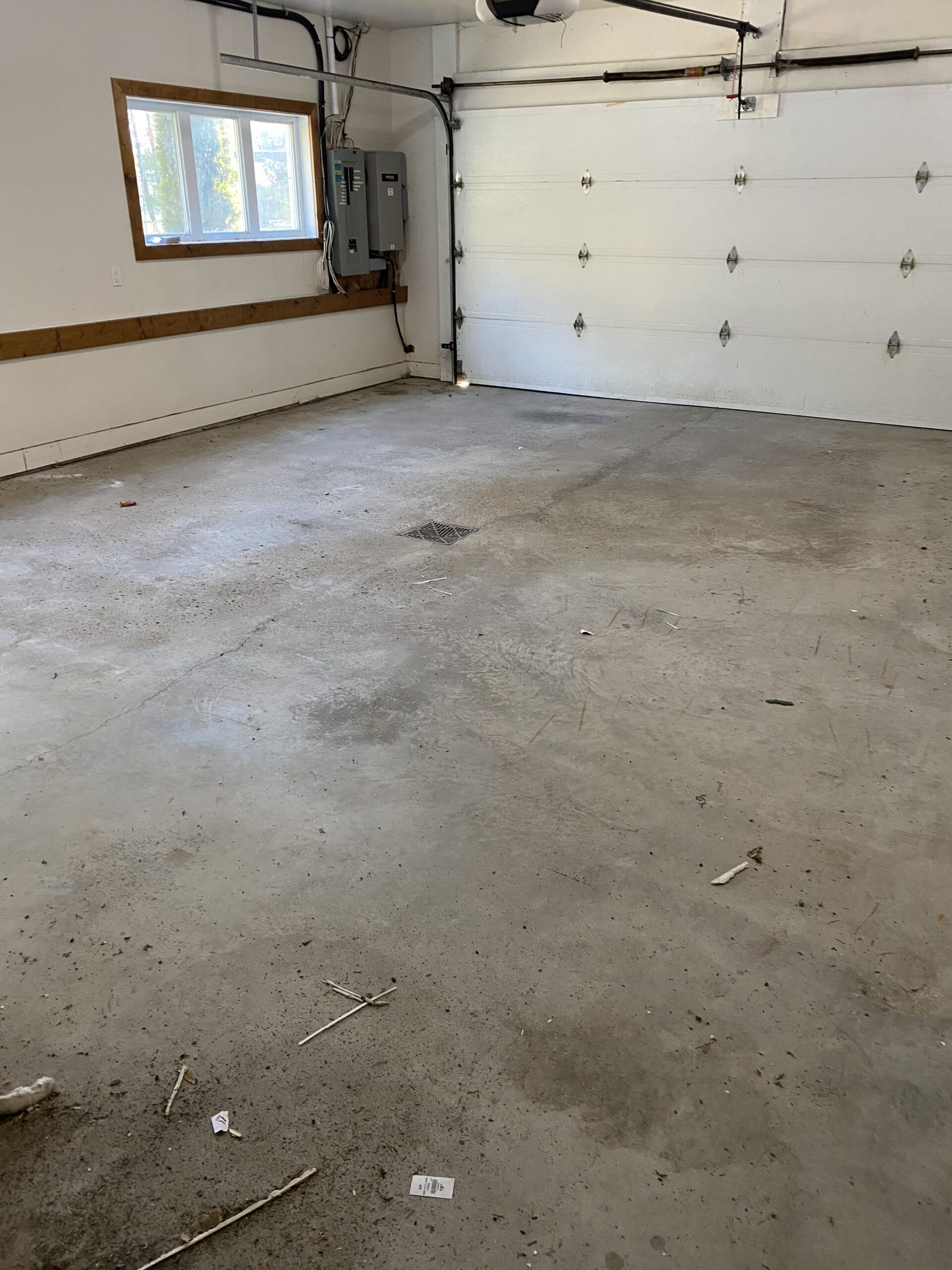 Before photo: Bare concrete floor, no coating or storage