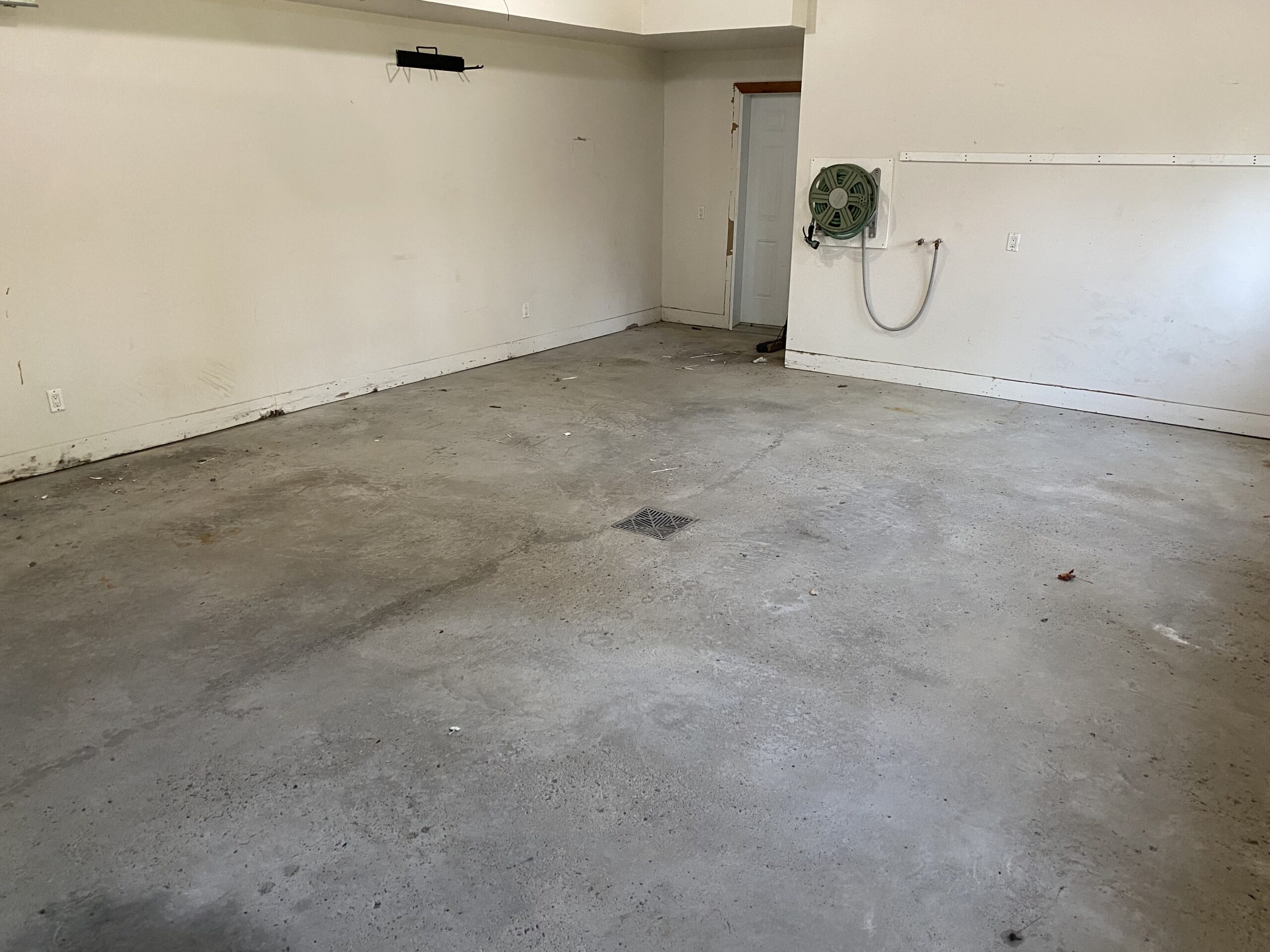 Before photo: Unfinished concrete floor and bare walls