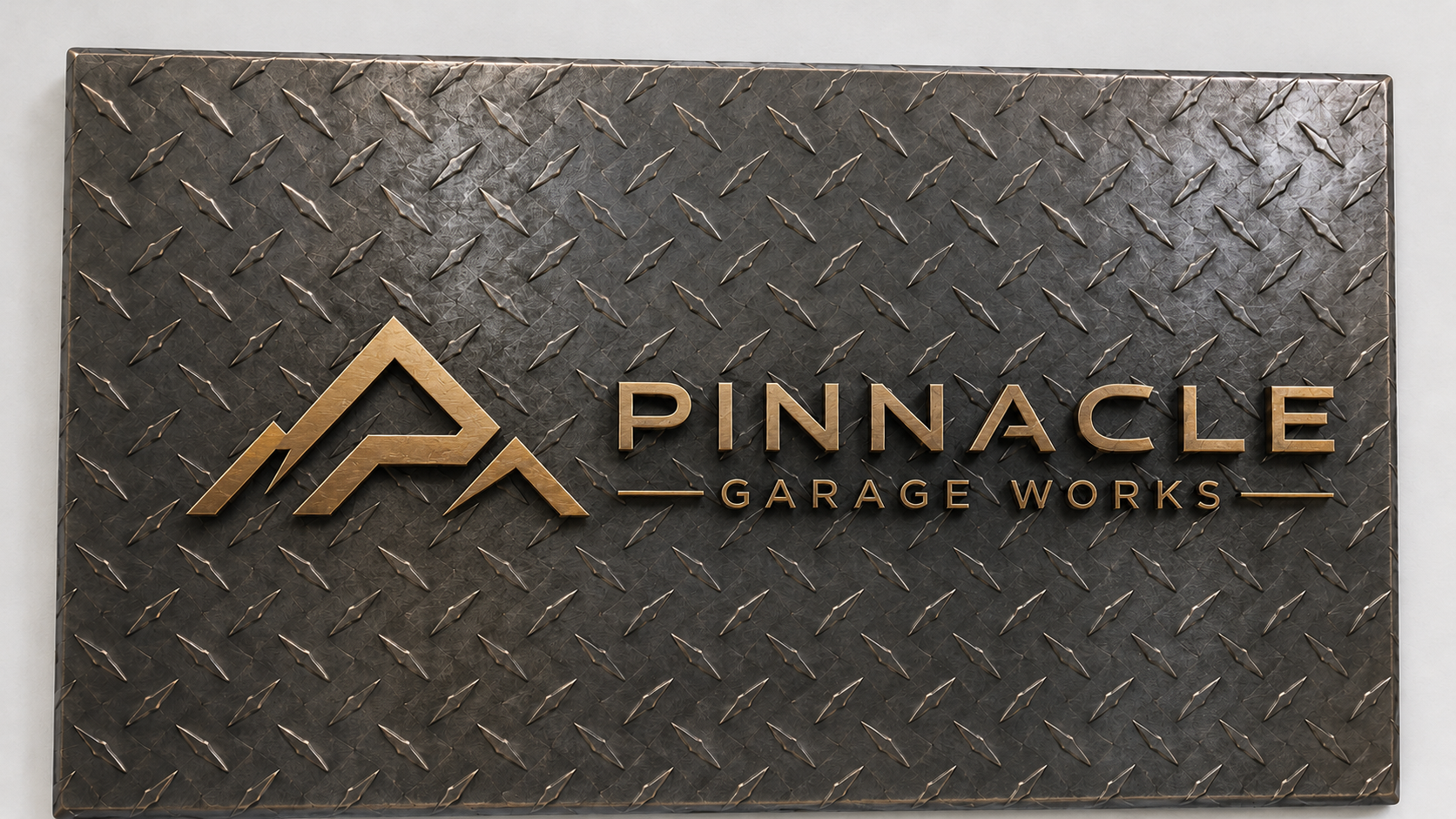 Diamond-plate metal sign with Pinnacle Garage Works logo